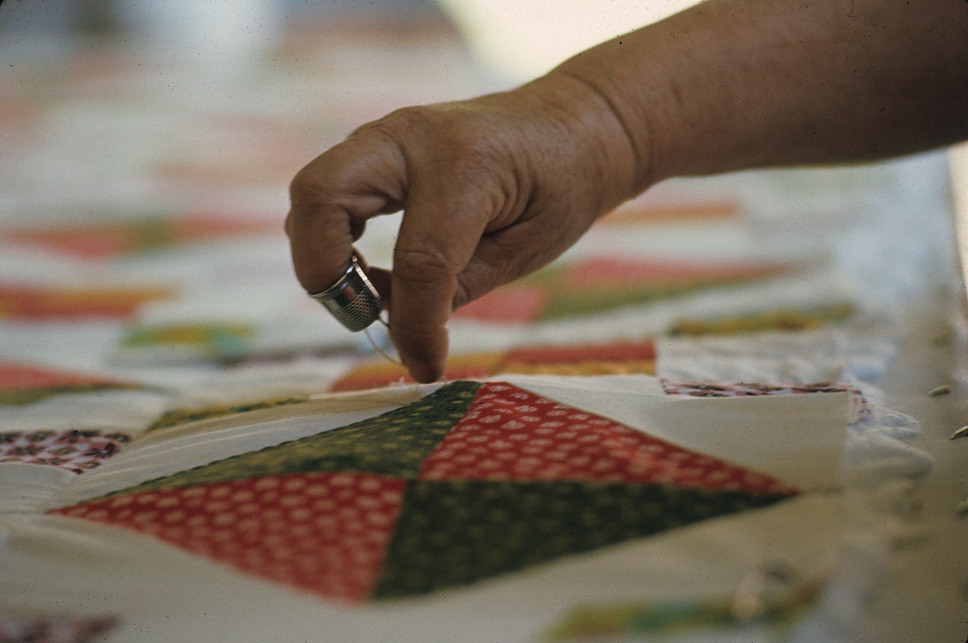 Volunteers working together on a quilt project.