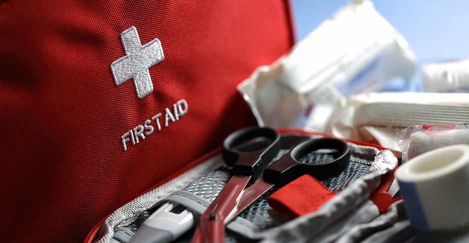 Safety signage and first-aid resources at a festival.